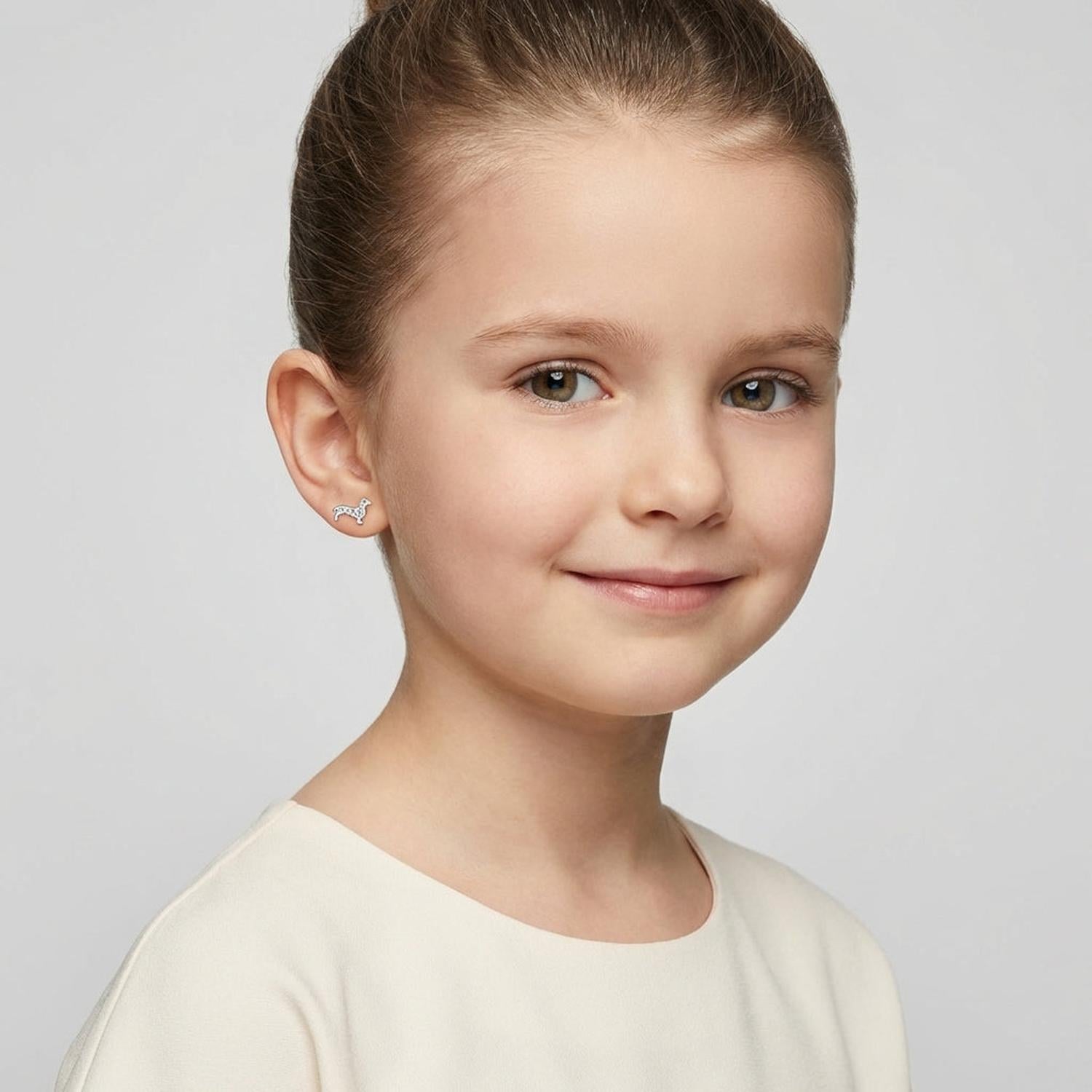 Melchior Jewellery sterling silver dachshund earrings worn by young girl with a smile
