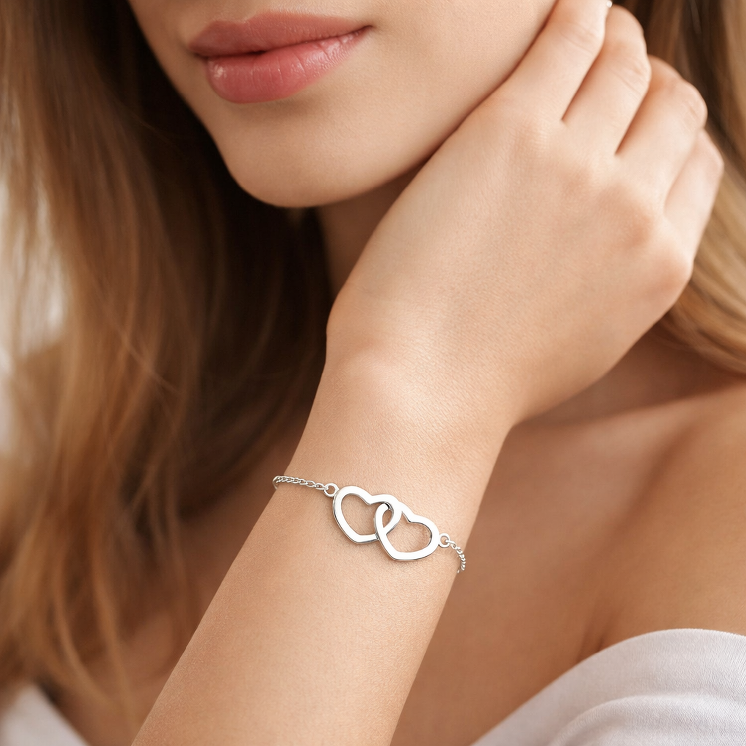 Melchior Jewellery sterling silver double heart bracelet worn on womans wrist with delicate chain