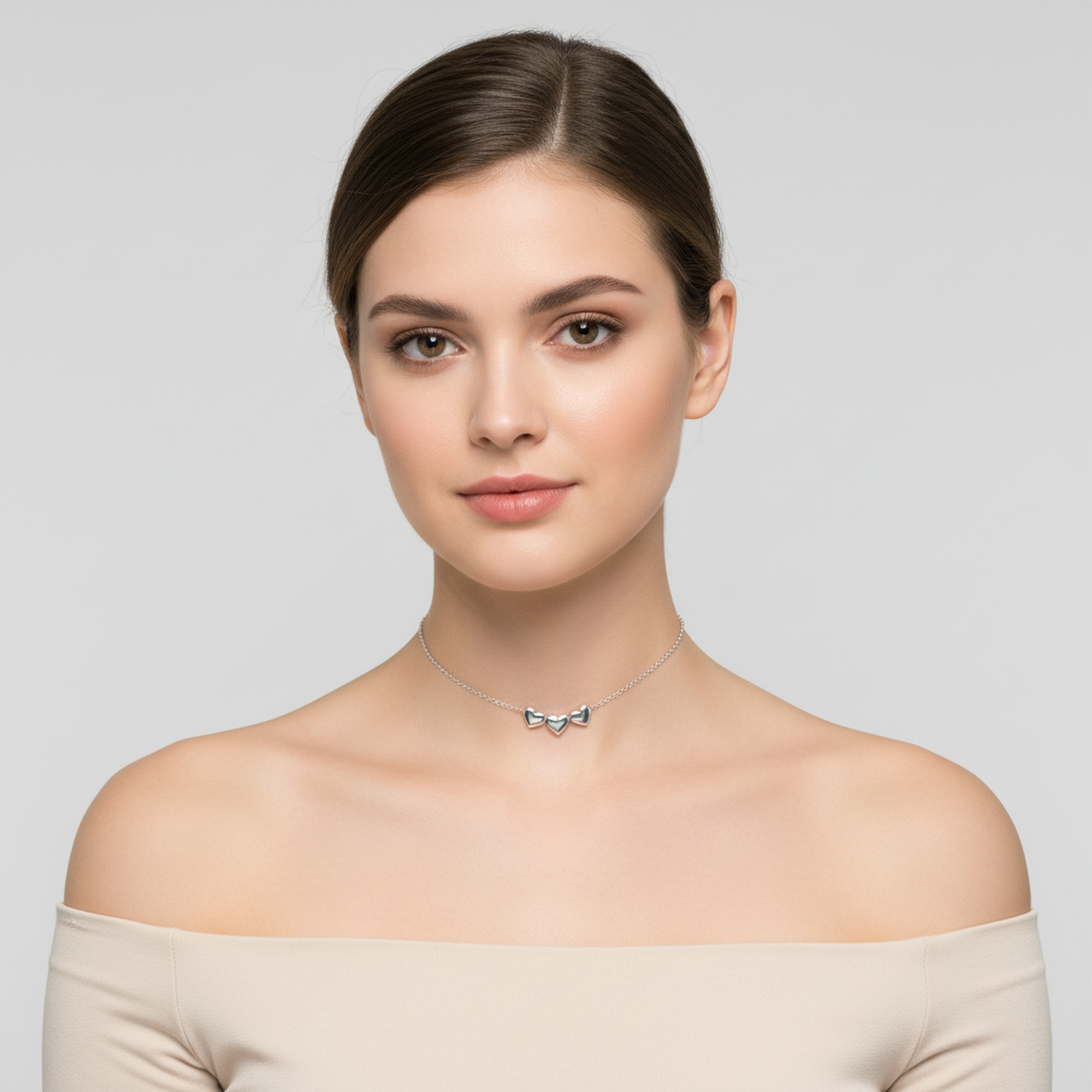 Melchior Jewellery sterling silver heart choker necklace worn by woman with off shoulder top