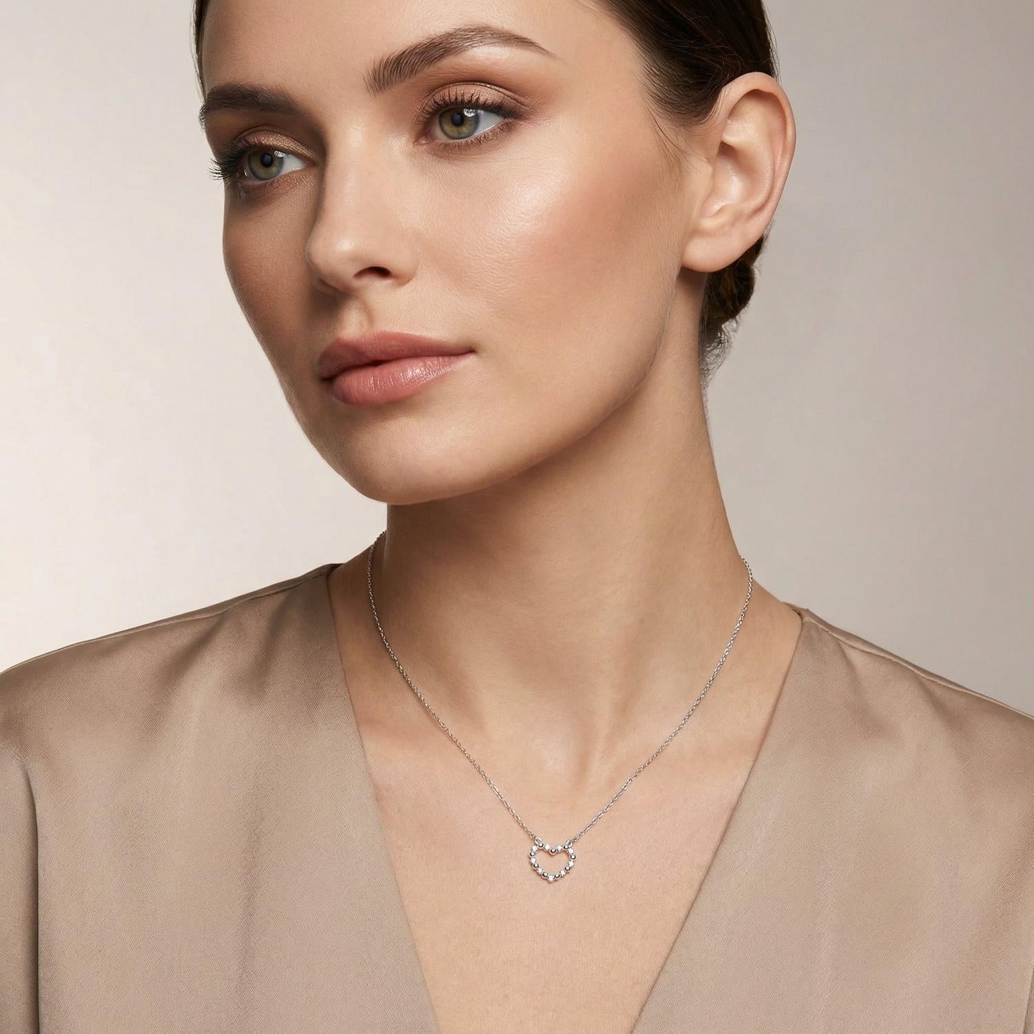 Sentiell sterling silver heart necklace for woman worn by model with beige top