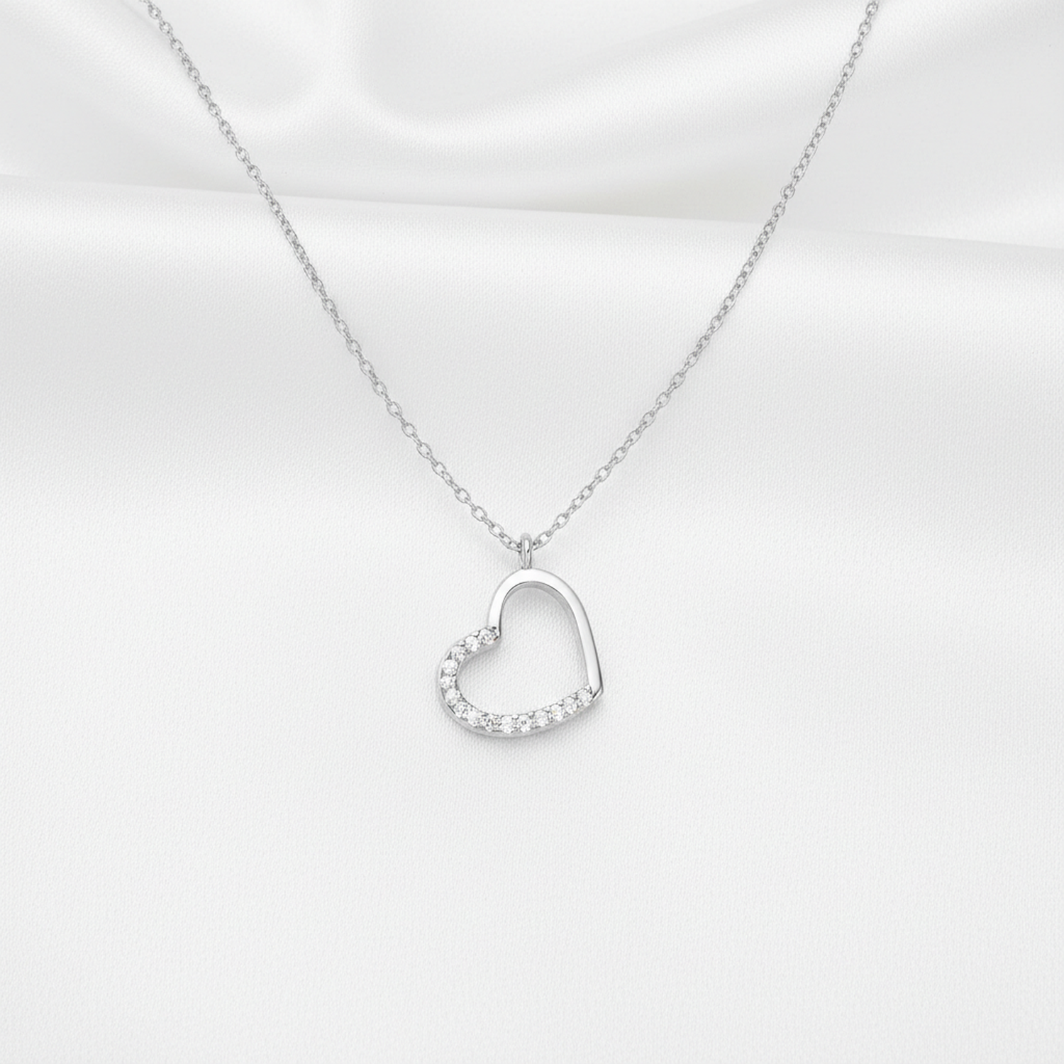 Delicate sterling silver heart necklace for women with sparkling clear crystals on half heart pendant