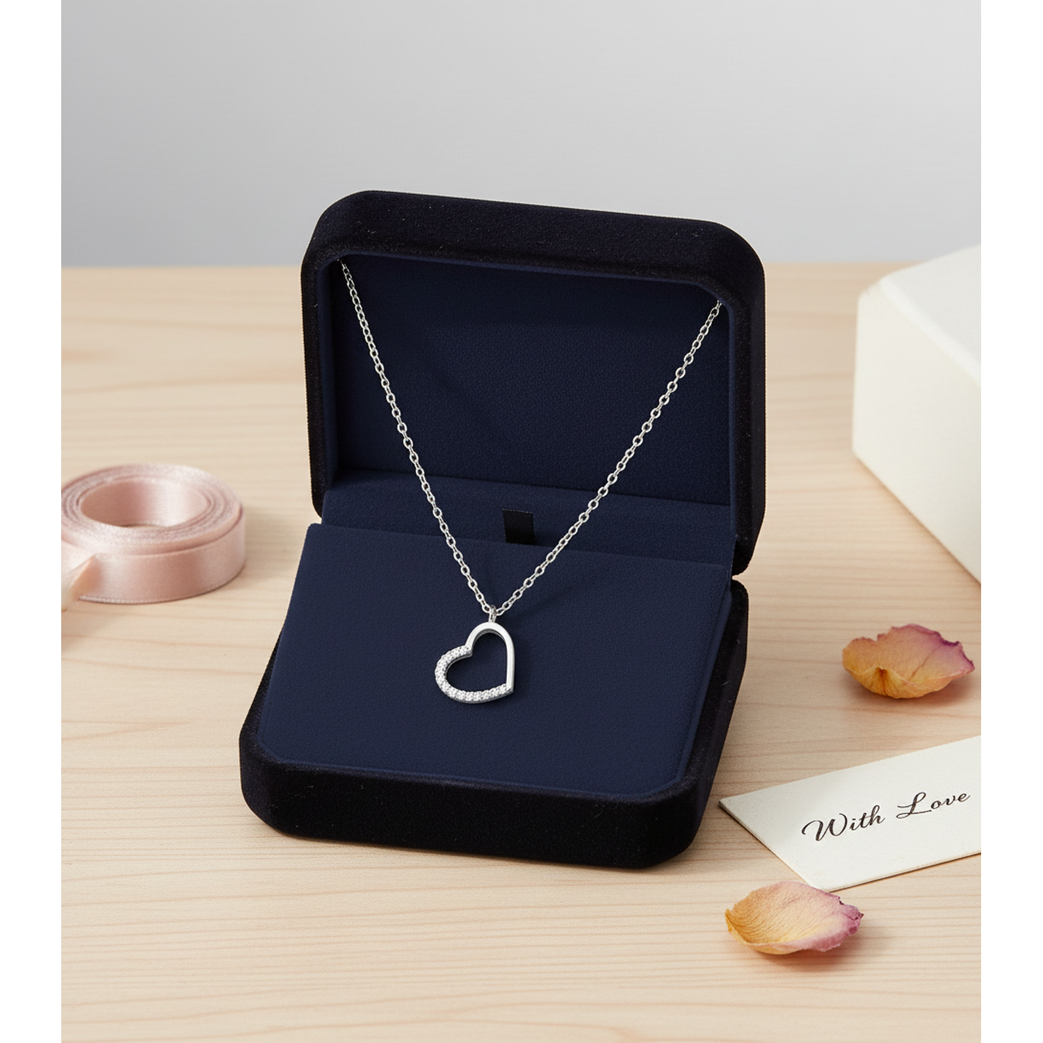 Sterling silver heart necklace for women with delicate chain in black velvet Melchior Jewellery box with pink ribbon and rose petals