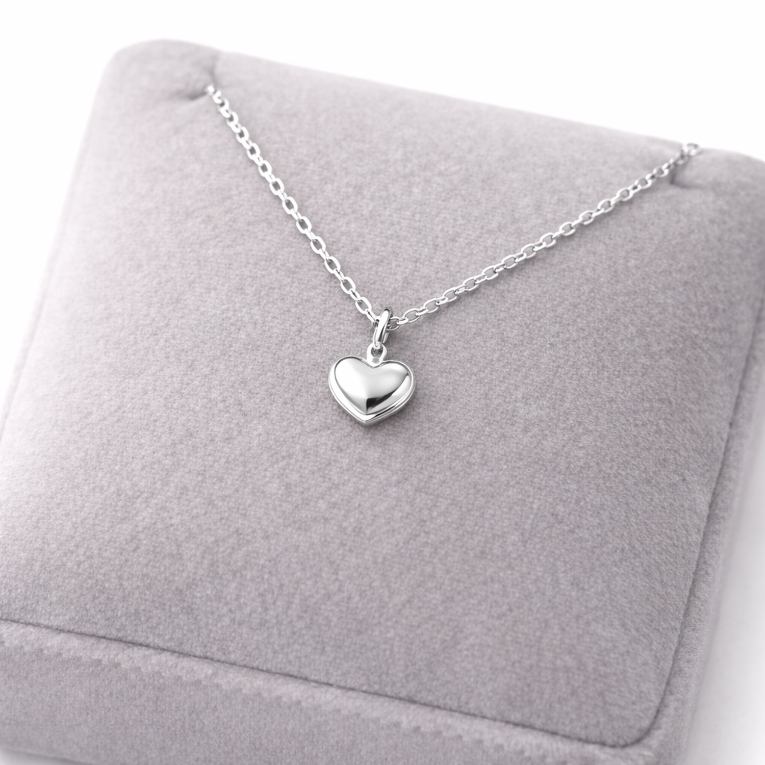Melchior Jewellery sterling silver heart necklace with delicate chain on grey cushion