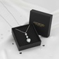 Sterling silver heart pendant necklace by Melchior Jewellery displayed in a black gift box on white fabric