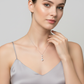 Woman wearing sterling silver heart pendant necklace from Melchior Jewellery with delicate chain and sparkling pendant