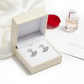 Melchior Jewellery sterling silver heart stud earrings displayed in a cream gift box with a rose petal and perfume bottle