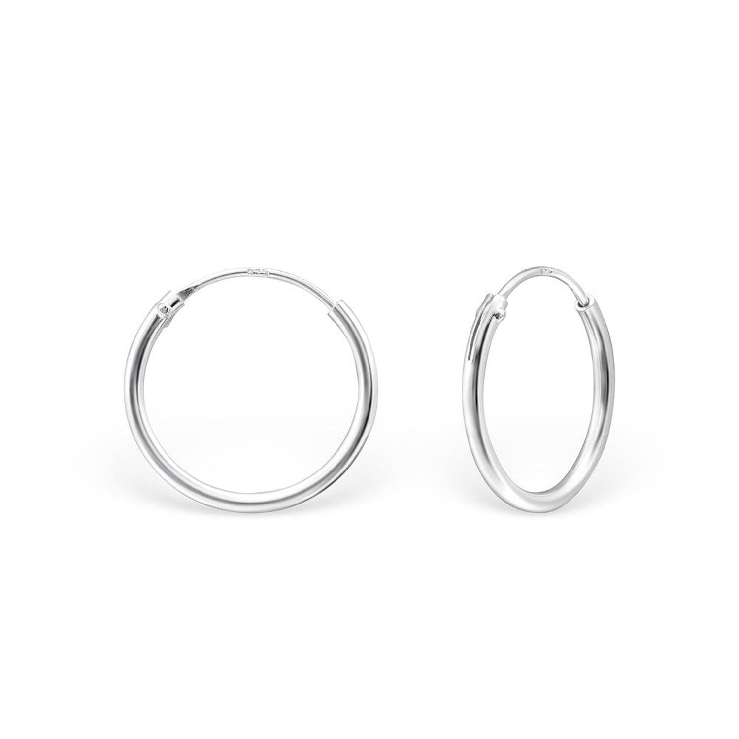 Melchior Jewellery polished pair of sterling silver hoop earrings on white background with hinge closure