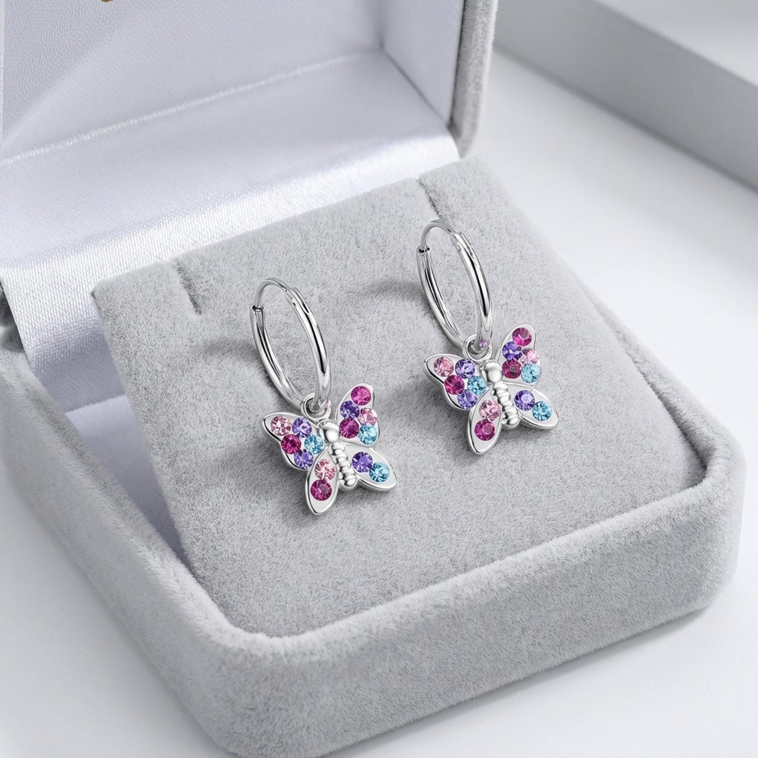Sterling silver kids butterfly earrings with pink and blue stones in a grey jewellery box by Melchior Jewellery