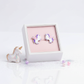 Sterling silver kids earrings unicorn design with purple and pink details in white jewellery box