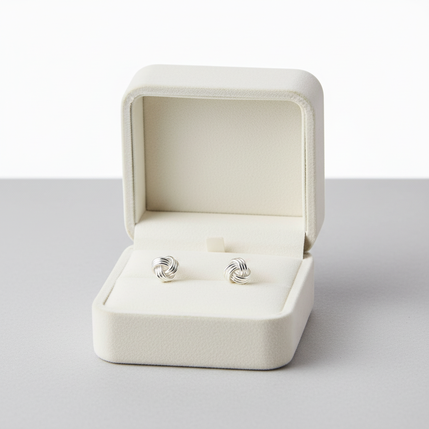 Melchior Jewellery sterling silver knot stud earrings displayed in a cream jewellery box for women