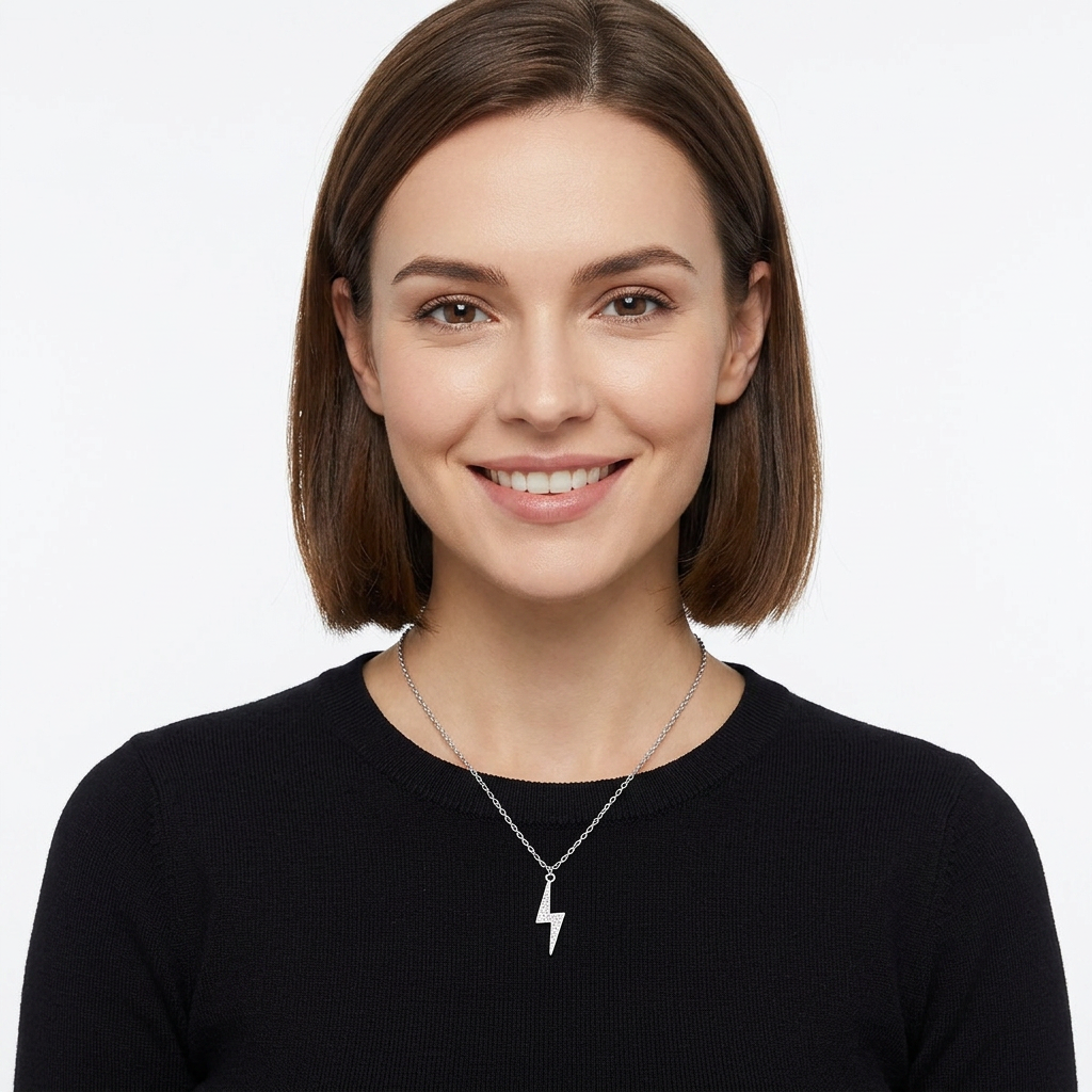 Smiling woman wearing a sterling silver lightning necklace on a delicate chain against a black top