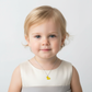 Child wearing a sterling silver necklace for children with a yellow duck pendant by Melchior Jewellery