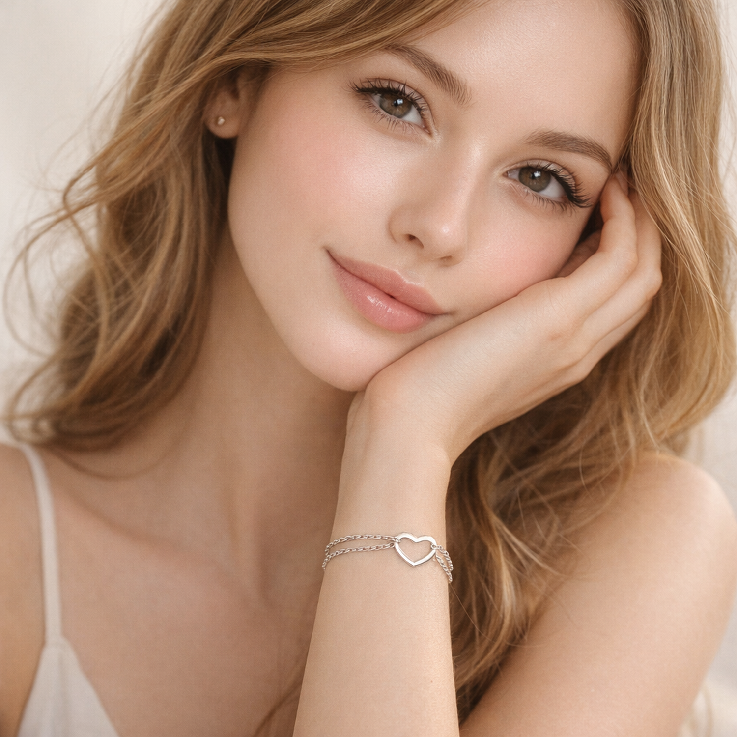 Melchior Jewellery sterling silver open heart bracelet worn on wrist by woman with fair skin and blonde hair