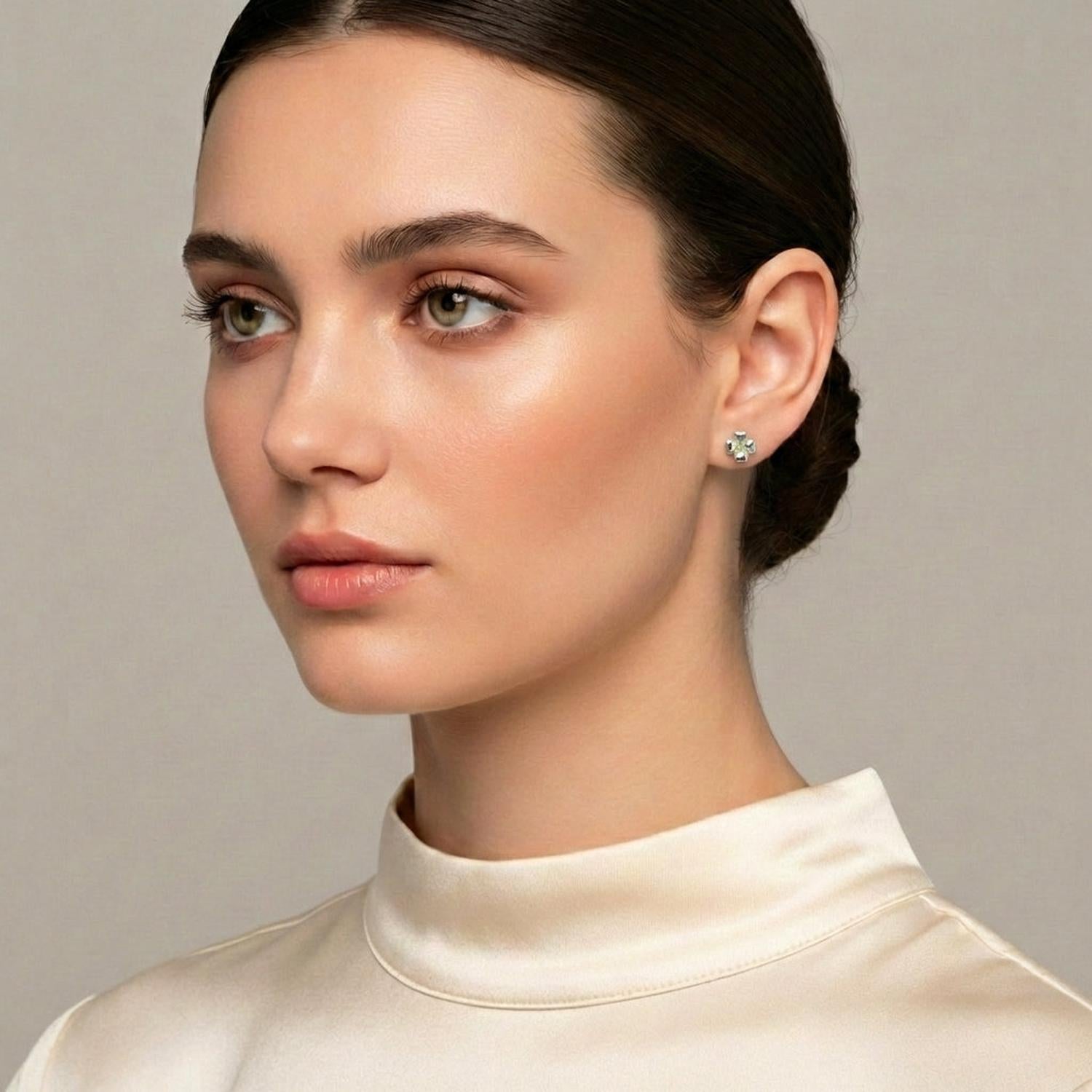 Melchior Jewellery sterling silver peridot stud earrings worn by woman with sleek hairstyle