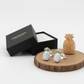 Melchior Jewellery sterling silver pineapple stud earrings displayed on wooden base with black gift box