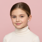Girl wearing sterling silver rabbit earrings for kids by Melchior Jewellery on pink background