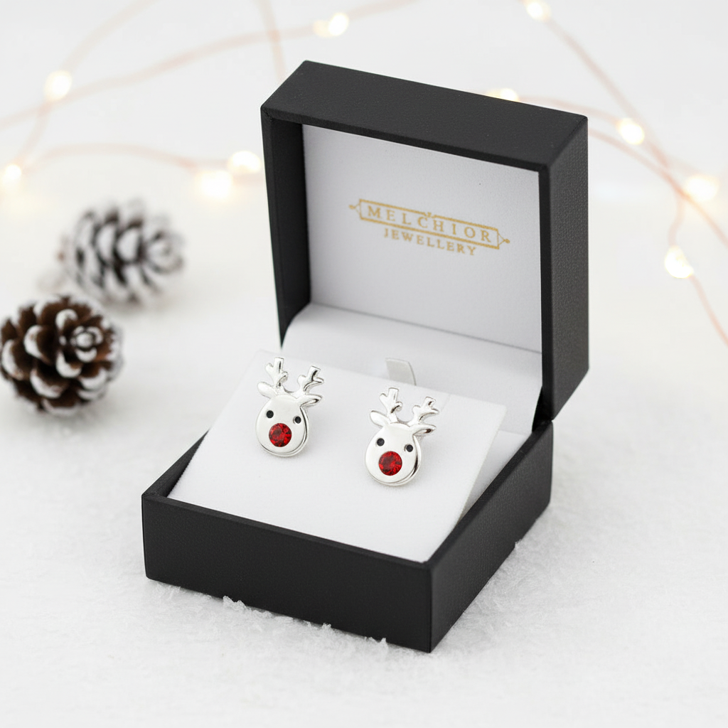 Sterling silver reindeer earrings with red nose in Melchior Jewellery black gift box on white background