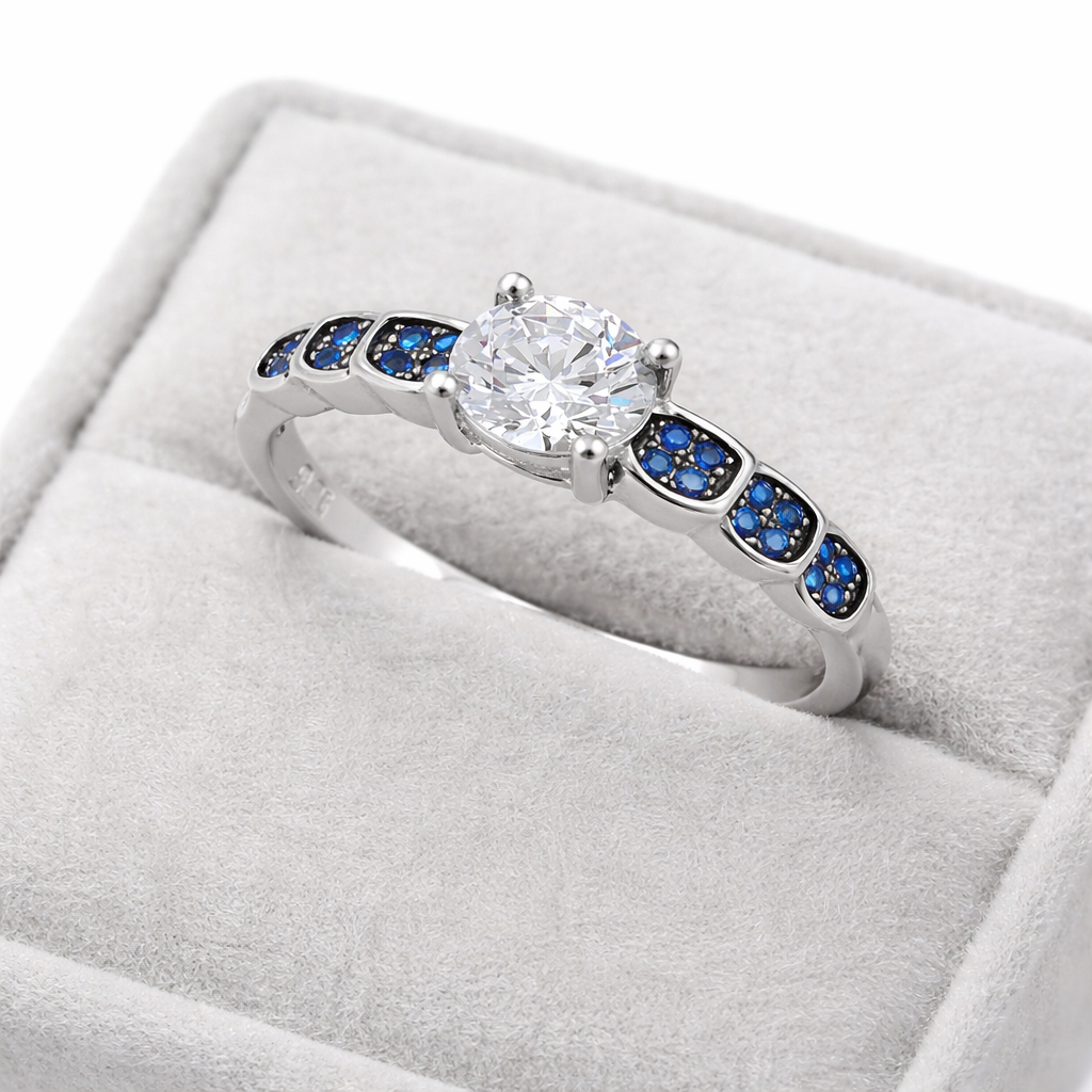 Melchior Jewellery sterling silver sapphire engagement ring with central clear stone and blue sapphires on band