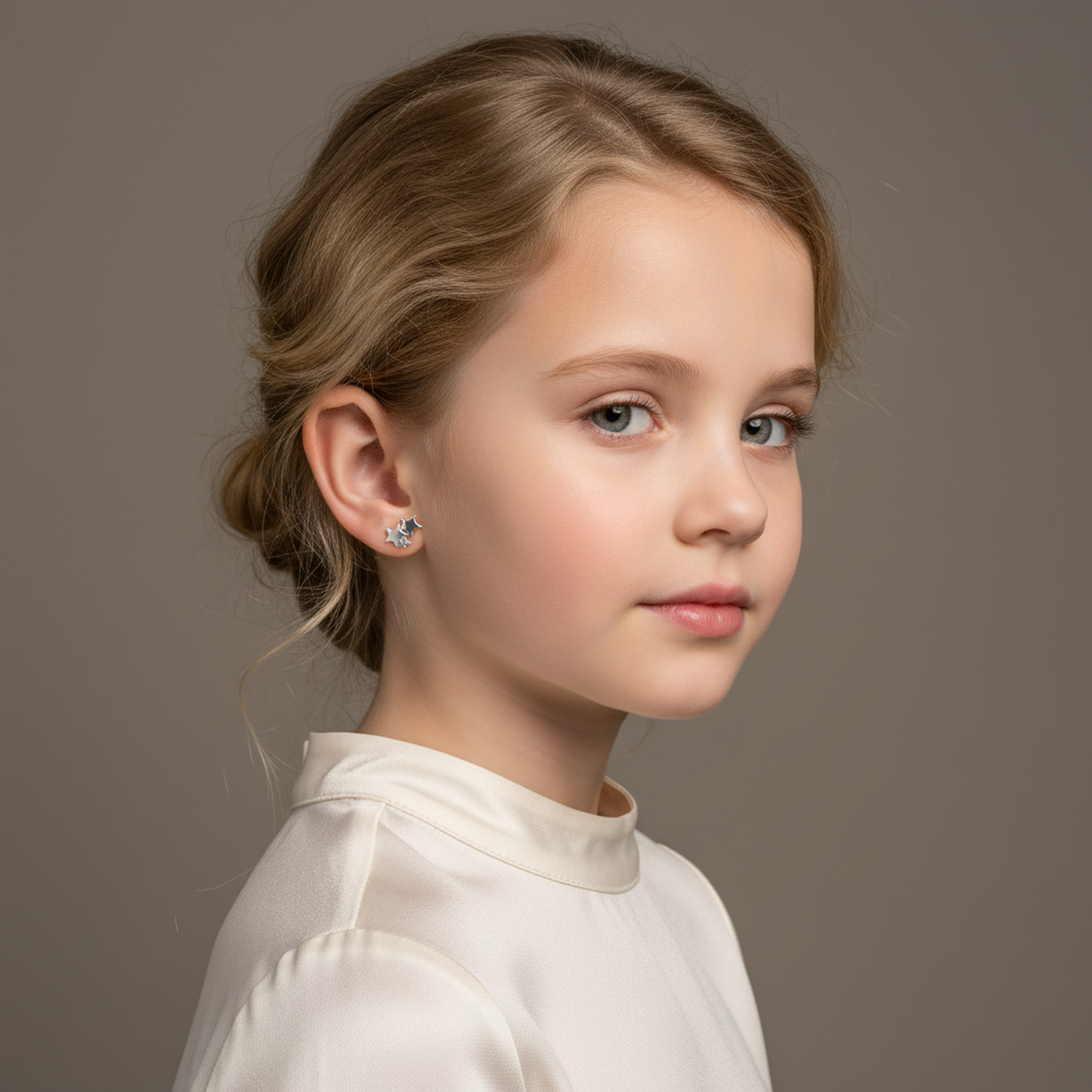 Young girl wearing Melchior Jewellery sterling silver star stud earrings with a subtle shiny finish