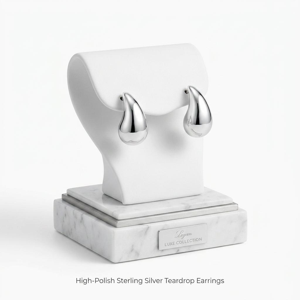 Sentiell high-polish Sterling Silver Teardrop Stud Earrings displayed on white marble stand
