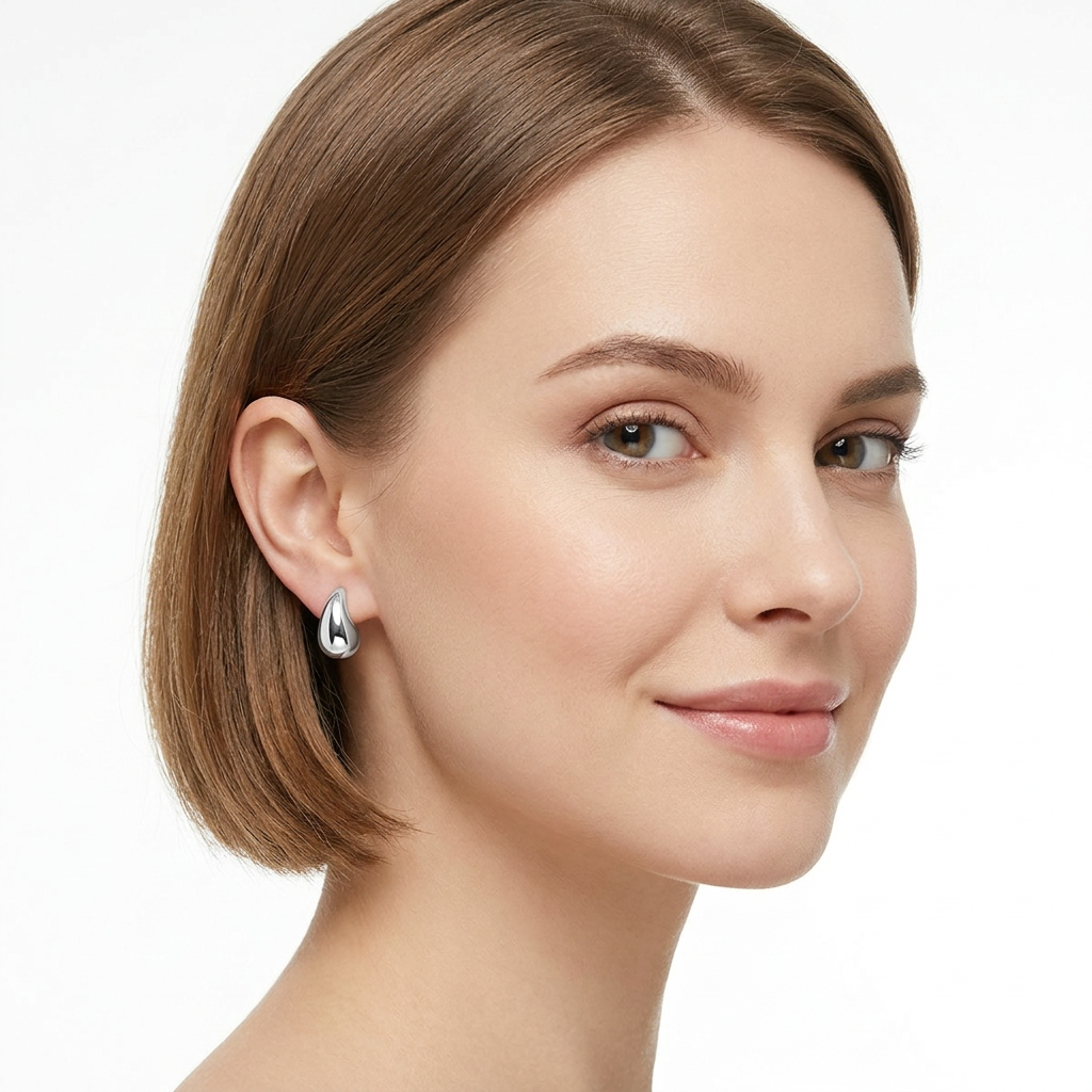 Sentiell sterling silver teardrop stud earrings worn by woman with short brown hair and clear skin