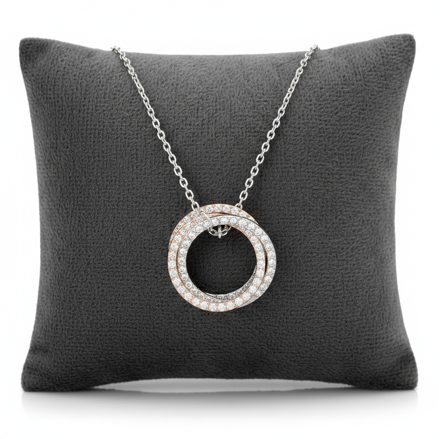 Melchior Jewellery sterling silver triple ring necklace with sparkling stones on a chain displayed on a grey cushion