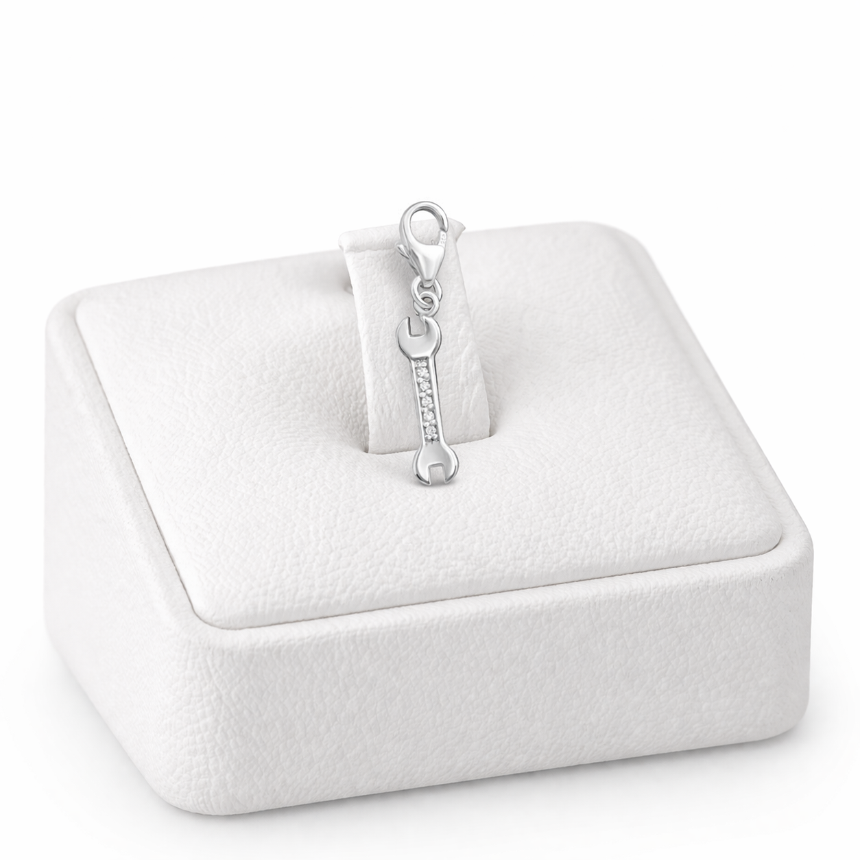 Silver tool clip on charm for bracelets shaped like a wrench with detailed engravings by Melchior Jewellery