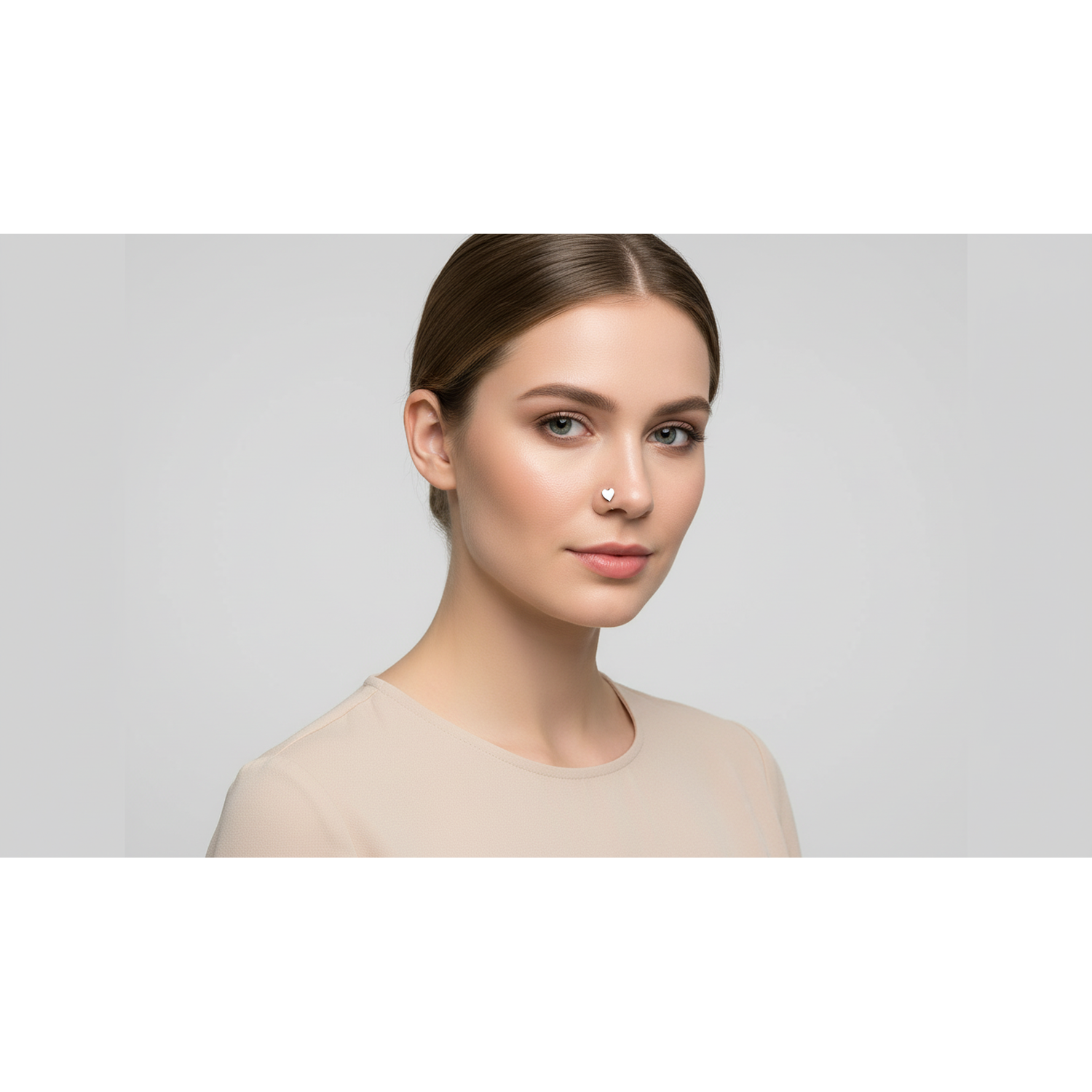 Melchior Jewellery implant grade titanium nose stud worn by woman with neutral makeup and beige top