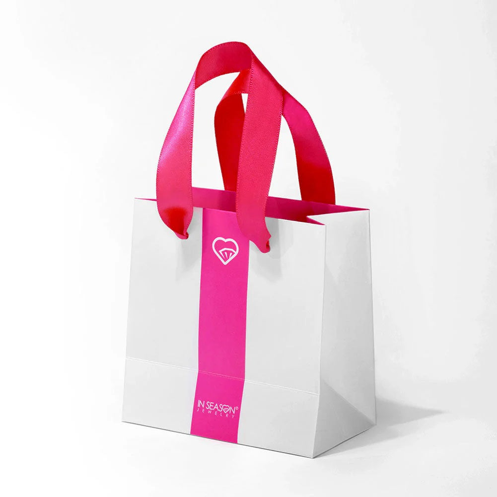 Melchior Jewellery luxury jewellery gift wrap bag in white with bright pink handles and logo