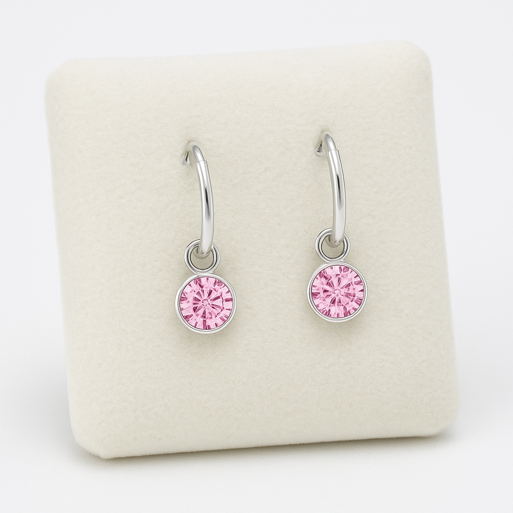 Melchior Jewellery sterling silver hoop earrings with delicate pink crystal dangle on soft cream display