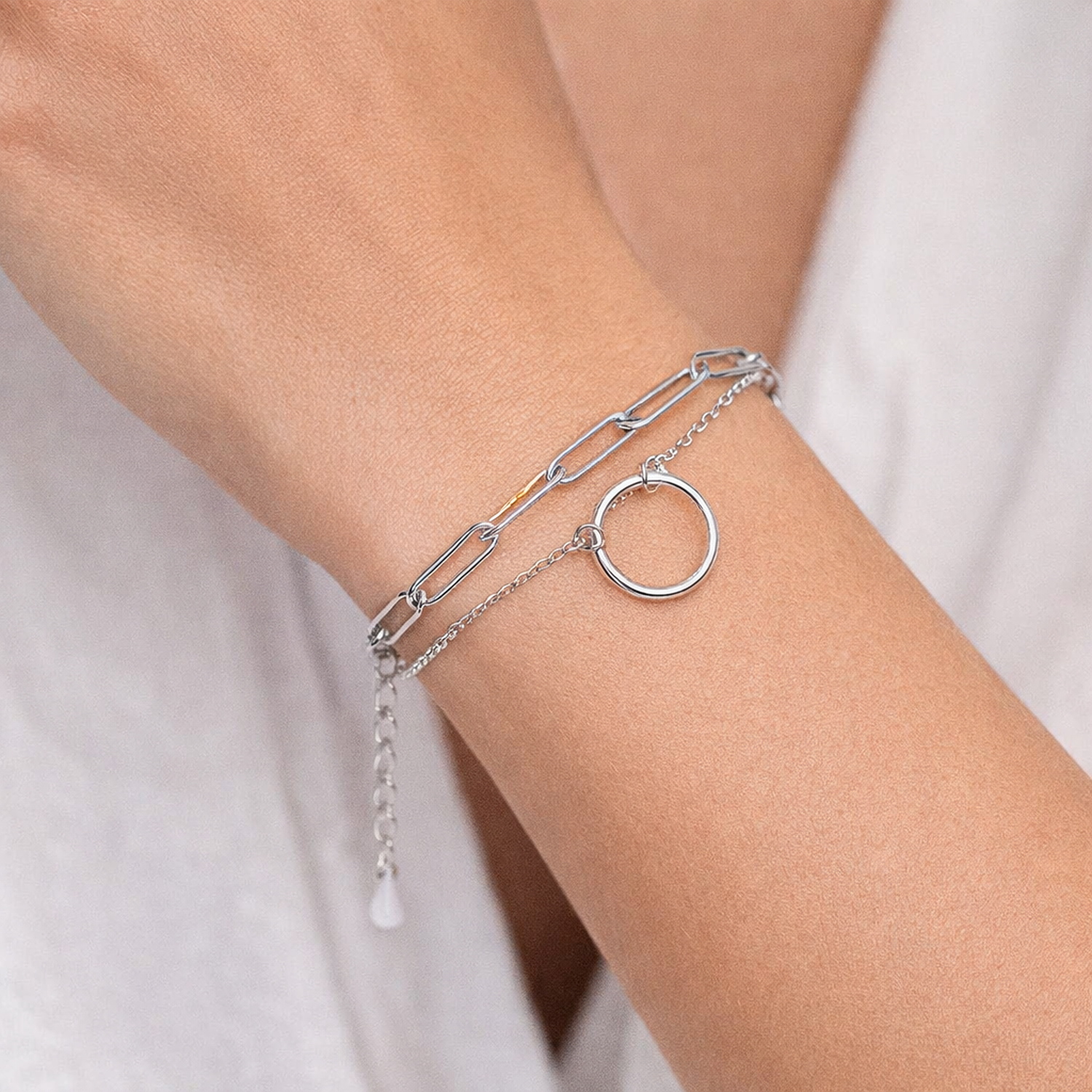 Sterling silver halo link bracelet with delicate chain and circular charm by Melchior Jewellery