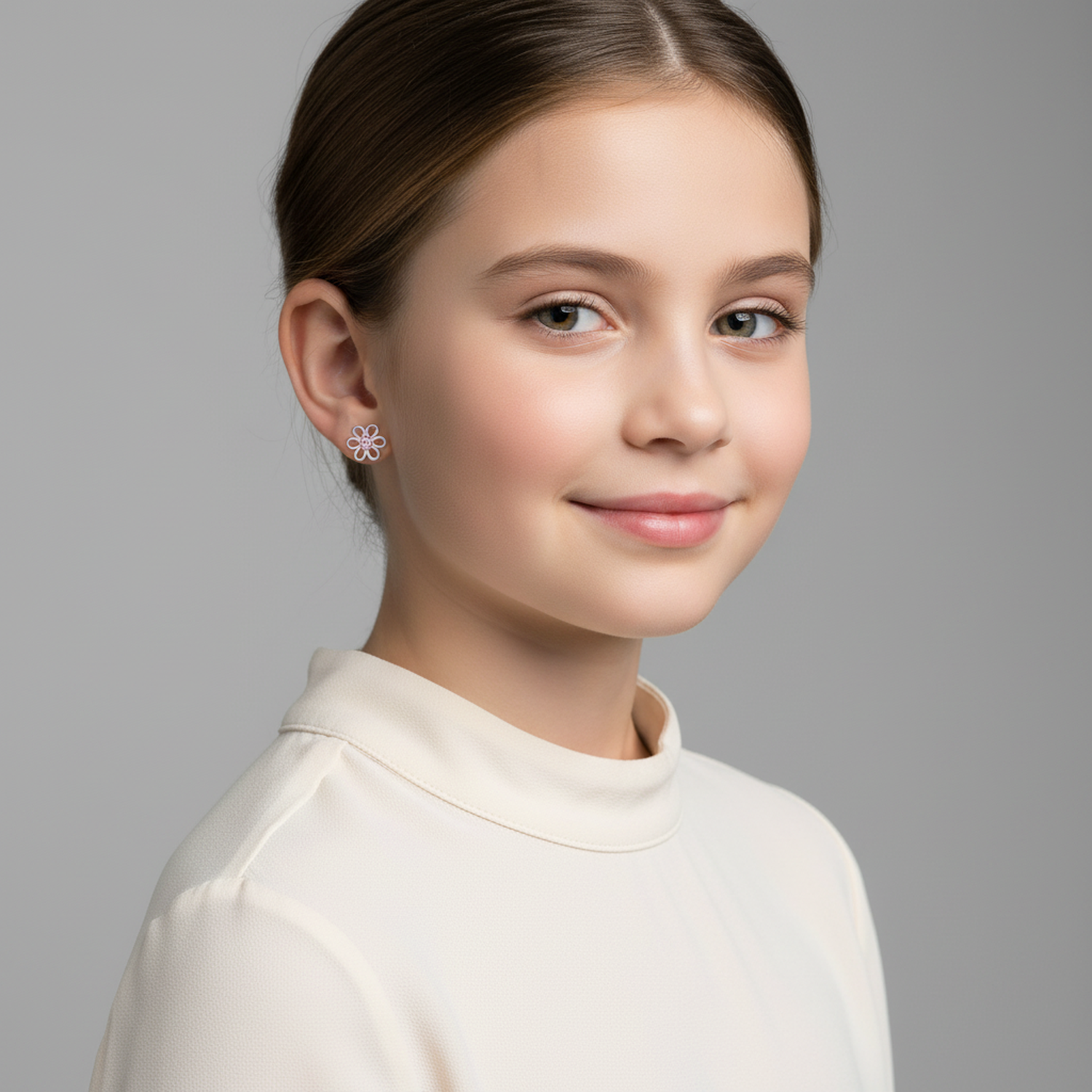 Girl wearing pink crystal stud earrings for girls from Melchior Jewellery with floral design