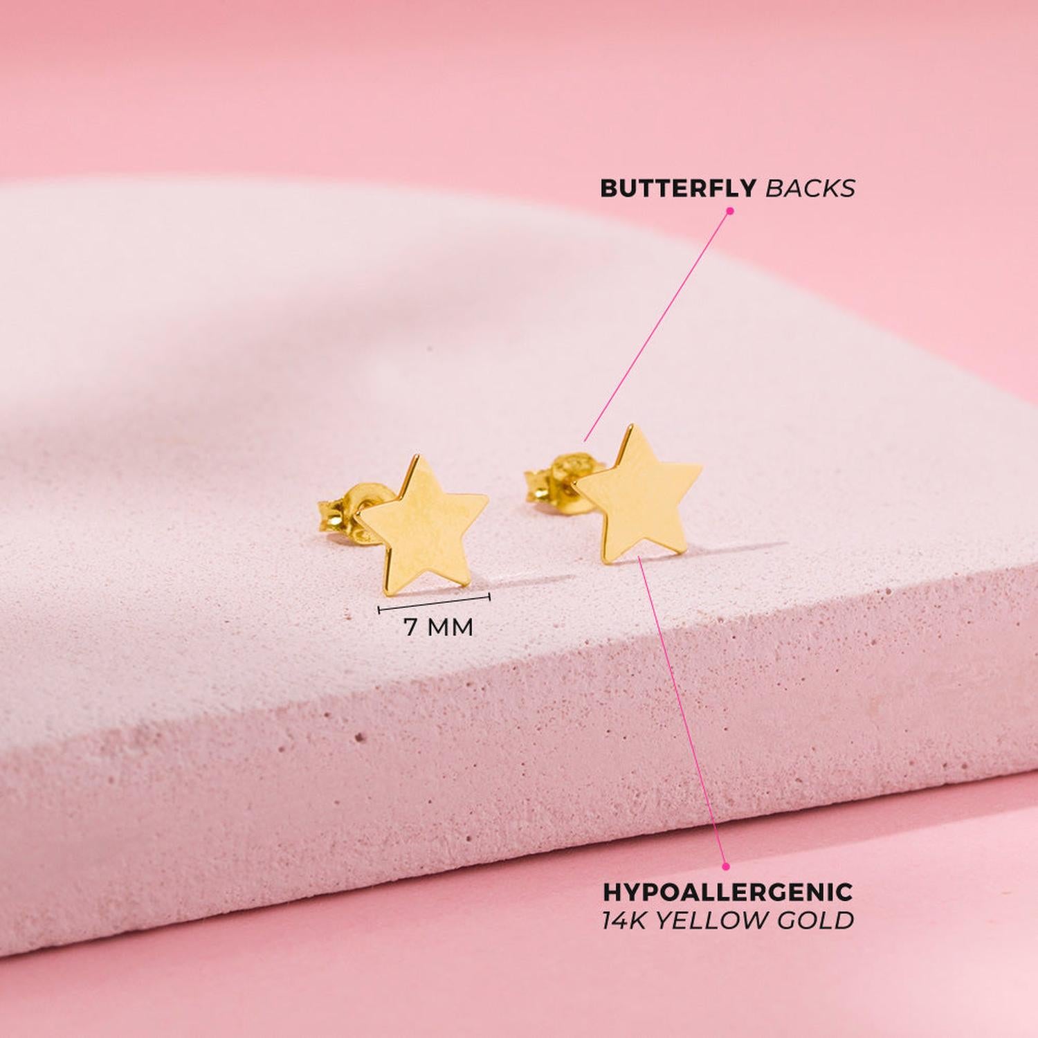 14k gold star stud earrings for girls in yellow gold with 7mm size and butterfly backs on pink background