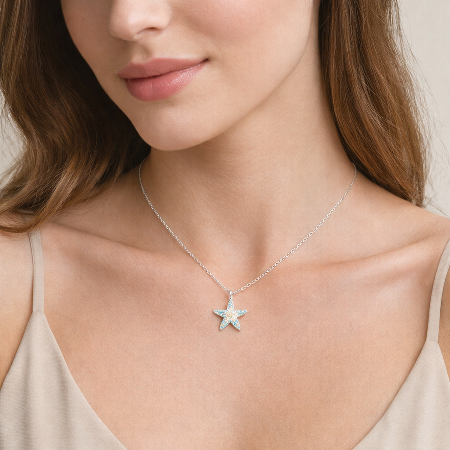 Melchior Jewellery sterling silver starfish necklace worn by woman with beige top