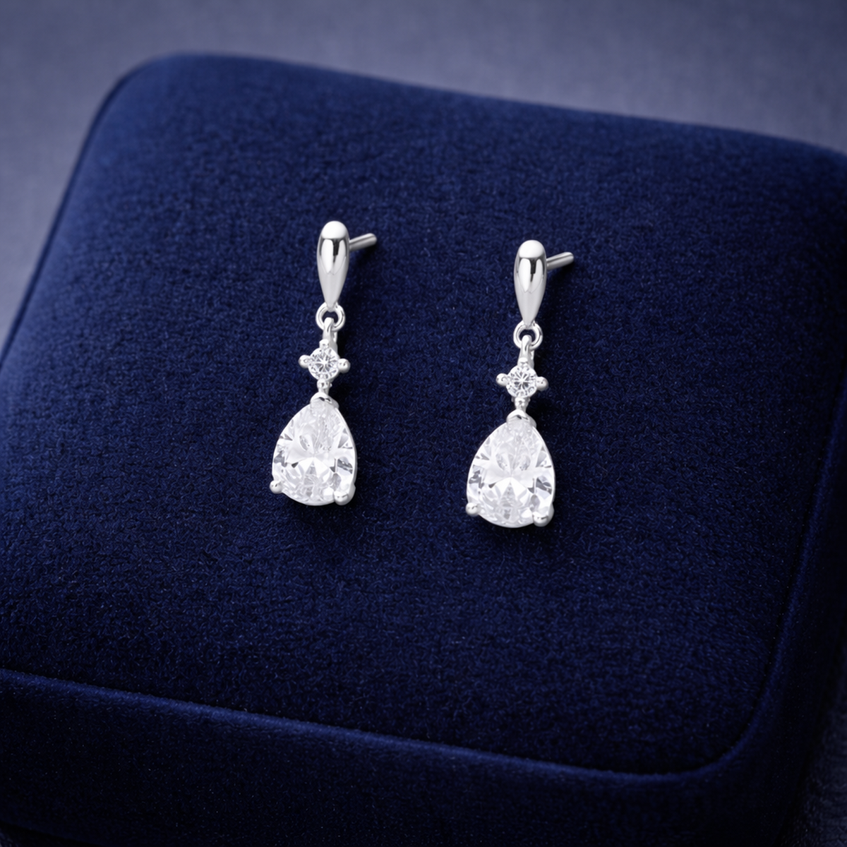 Melchior Jewellery Sterling Silver CZ Teardrop Bridal Earrings displayed on navy blue velvet background