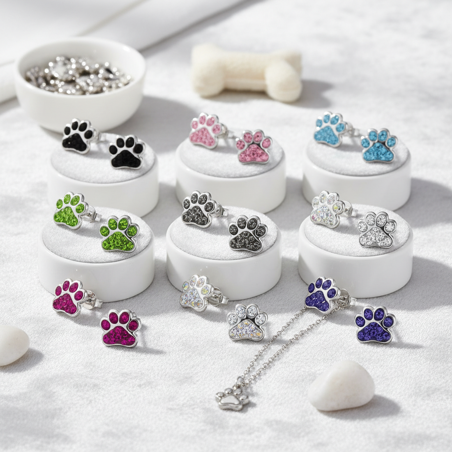 Melchior Jewellery sterling silver dog paw stud earrings for children in various colours displayed on white stands