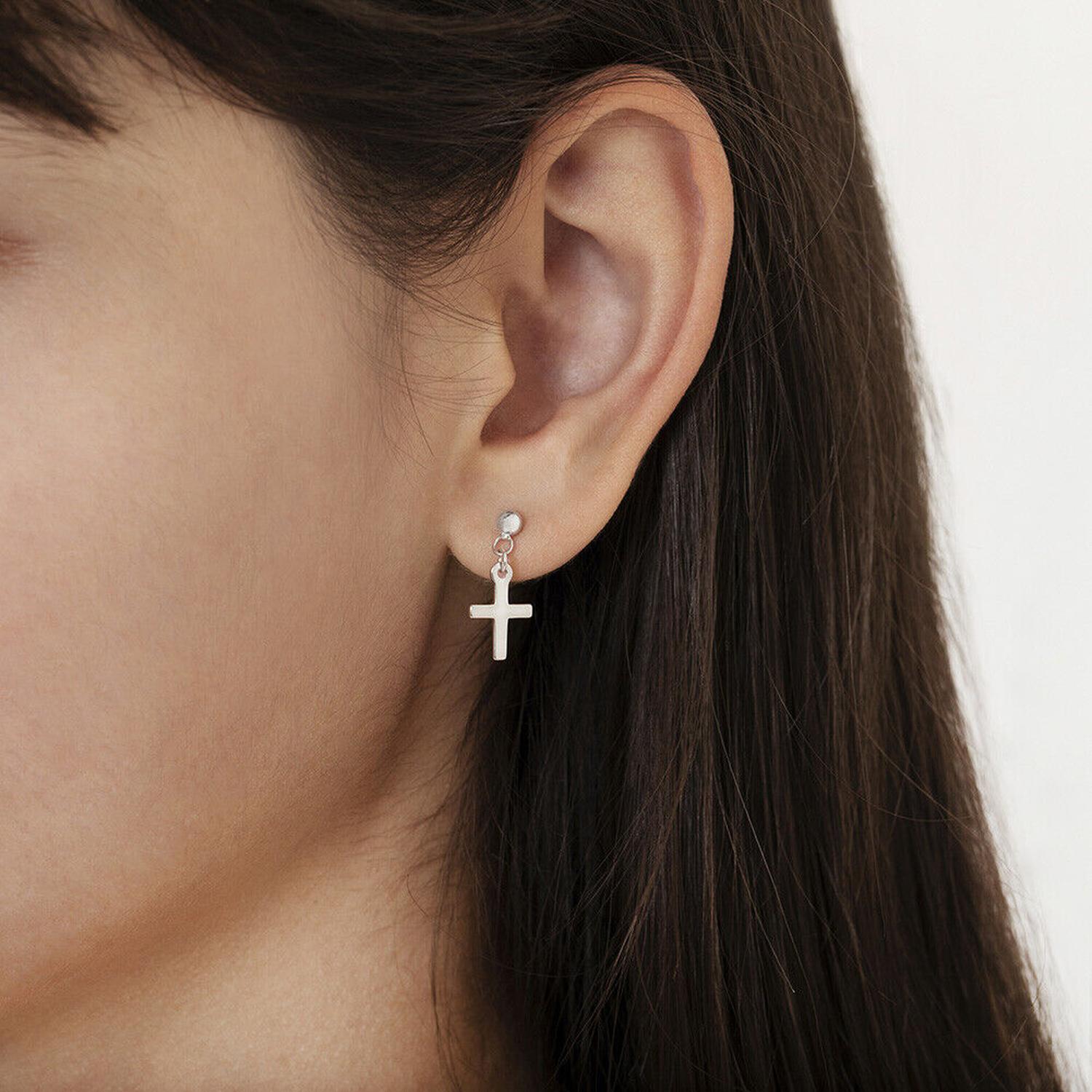 Sterling silver girls earrings dangle cross earrings worn by child with long dark hair