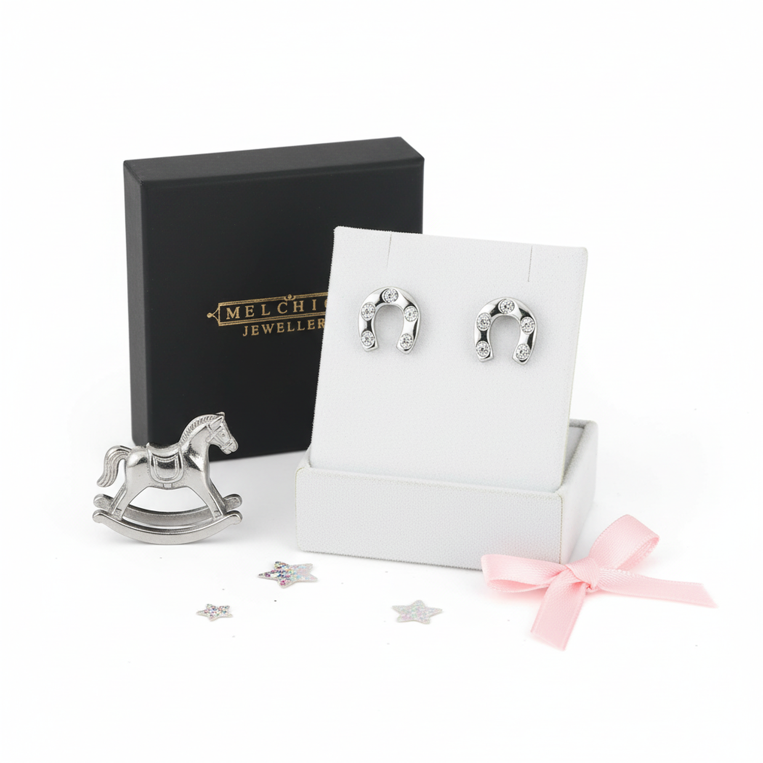 Melchior Jewellery sterling silver horseshoe earrings displayed with black box and horse figurine