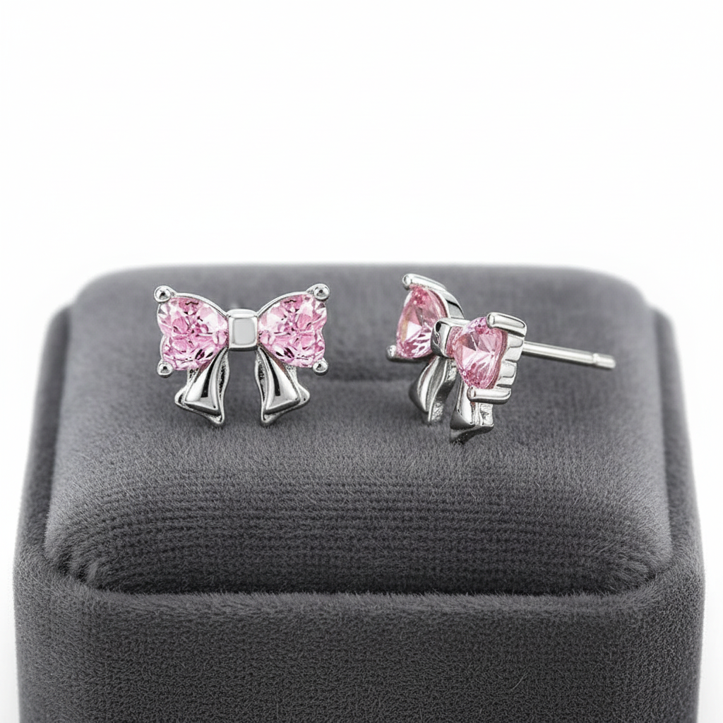 Melchior Jewellery sterling silver pink bow earrings with delicate pink gemstones on grey display