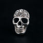 Melchior Jewellery sterling silver skull stud earrings with crystal embellishments on black background