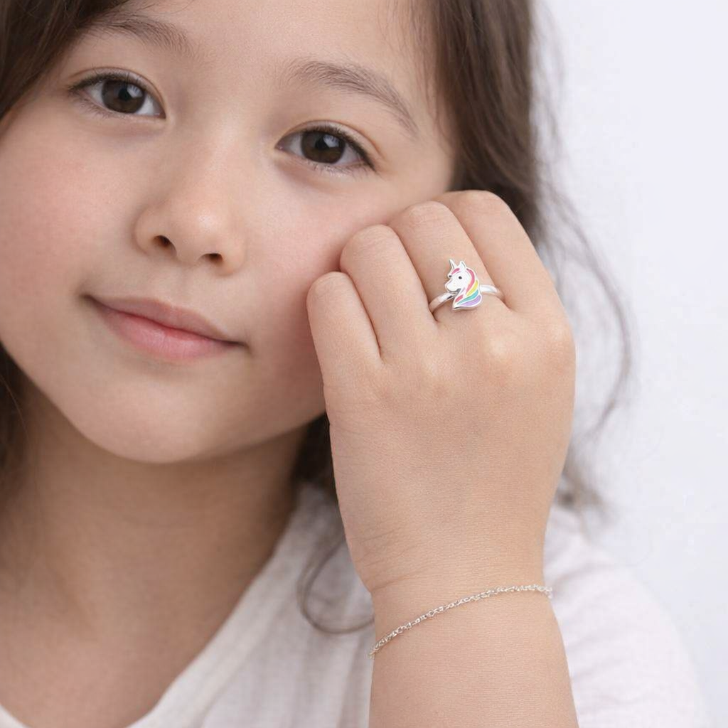 Unicorn sterling silver ring with rainbow details on childs hand from Melchior Jewellery childrens rings