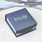 Navy jewellery presentation box with Meilys logo on wooden surface for AB crystal sterling silver earrings