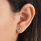 Delicate 14k yellow gold heart earrings with diamonds worn on ear by Melchior Jewellery