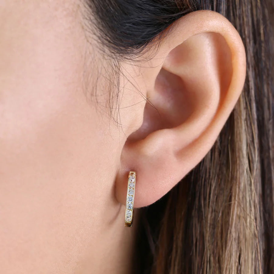 Melchior Jewellery gold hoop earrings with clear CZ worn on ear for elegant style