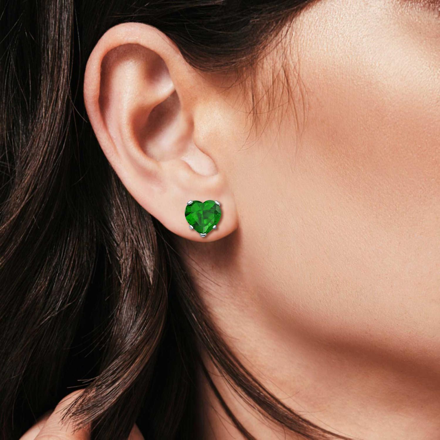 Melchior Jewellery heart-shaped green may birthstone earrings worn on ear with dark hair