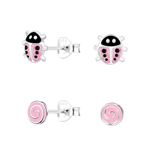 Melchior Jewellery pink stud earrings for kids featuring ladybird and swirl designs in sterling silver